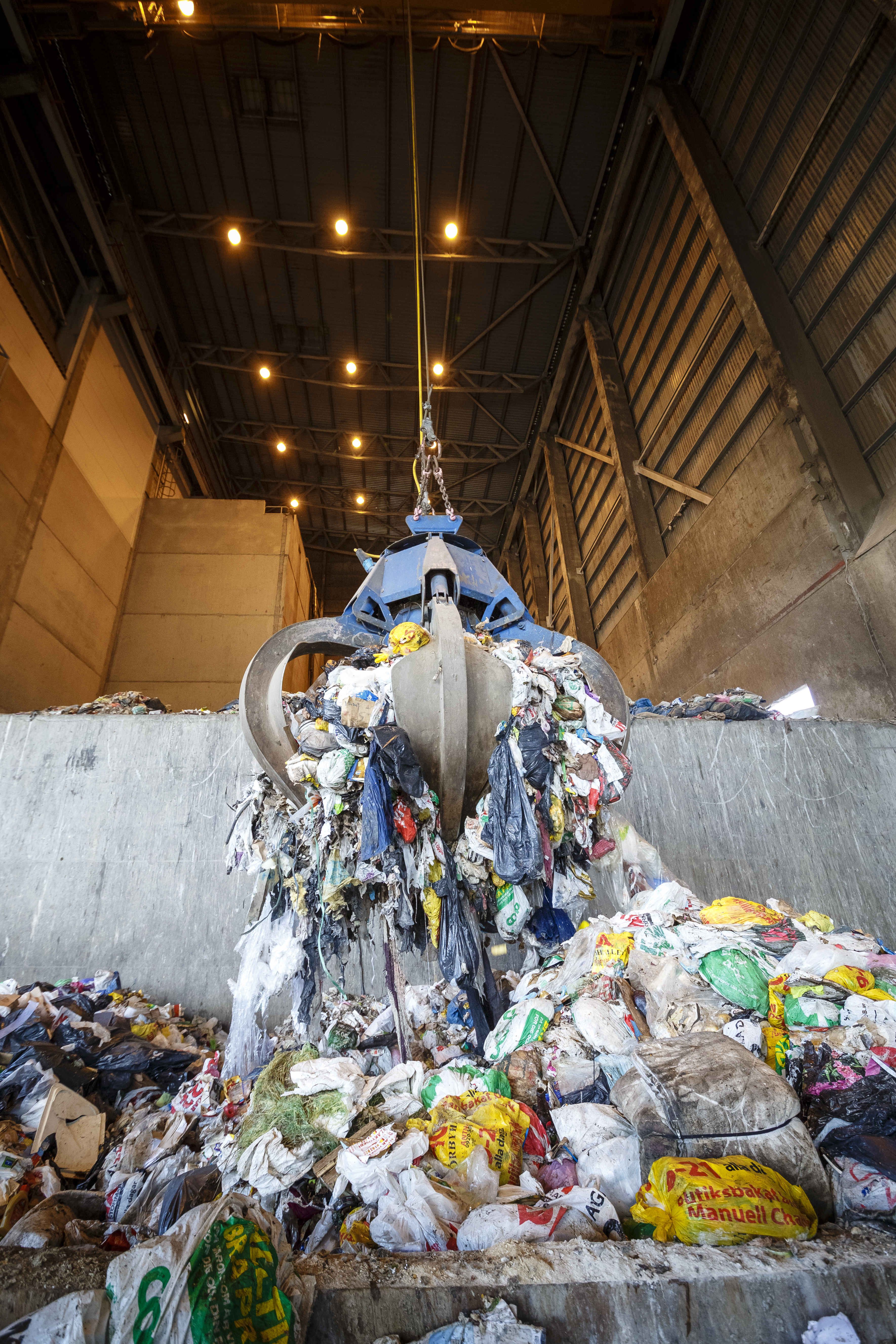 En stor gripklo som lyfter sopor. Foto